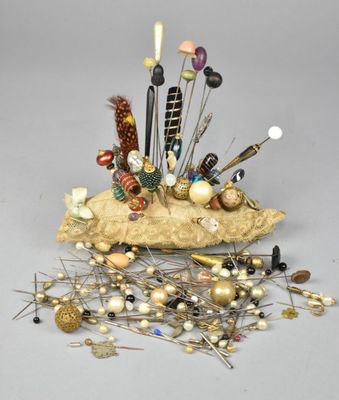 a pile of pins and needles sitting on top of a rock