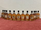 six bottles of whisky lined up in a row on a table
