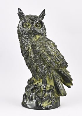 une image représentant une statue de chouette perchée sur une souche d'arbre