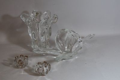 a glass vase and other glass objects on a white surface
