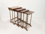 three wooden nesting tables sitting on top of a white floor