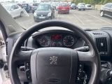 dashboard of a car with a steering wheel in a parking lot
