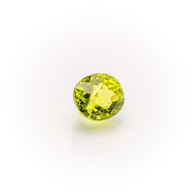 a yellow sapphire stone on a white background