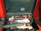 a tool in a green case on a red table
