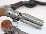 two guns that are sitting on a table