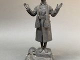 statue of a man standing on a rock with his arms outstretched