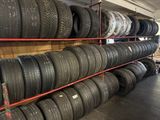 tires are stacked on a rack in a tire shop