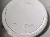 a white robot that is sitting on the floor