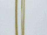 a close up of a gold heart necklace on a white background