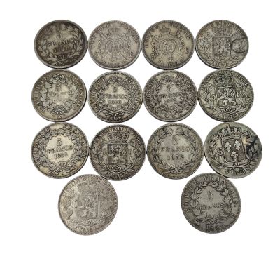 an image of a group of silver coins sitting on top of a white surface