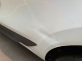 a close up of a car ' s front bumper and fender