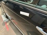 a black car with a sticker on the side of it