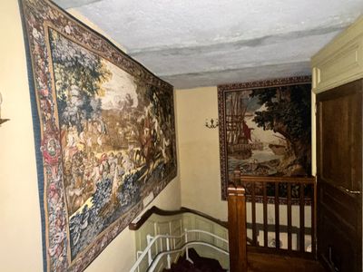 an image of a hallway with a tapestry hanging on the wall