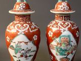 two vases sitting next to each other on a table