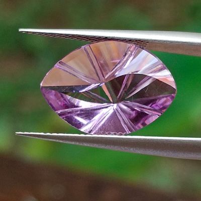 someone is holding a pair of pliers with a purple diamond