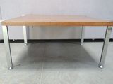 a wooden table with metal legs and a wooden top