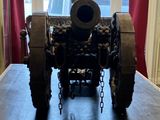 a cannon sitting on top of a table in front of a window