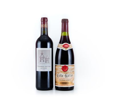 two bottles of wine sitting next to each other on a white surface