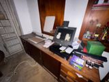 a desk with a laptop computer and other items on it