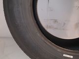 a close up of a tire on the side of a white wall