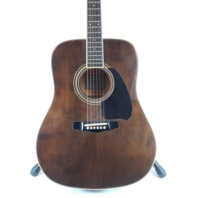 a guitar that is sitting on a stand on a white background
