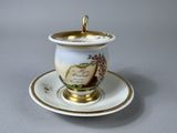 a cup and saucer on a saucer on a table