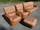 a couch and ottoman sitting in the middle of a parking lot