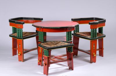 three chairs and a table with a red table top