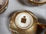 many cups and saucers that are sitting on a table