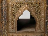 a wooden cabinet with a carved design on it