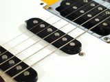 an electric guitar sitting on top of a table with a white background