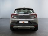 the rear end of a silver car in a white room
