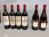 several bottles of wine are lined up on a table