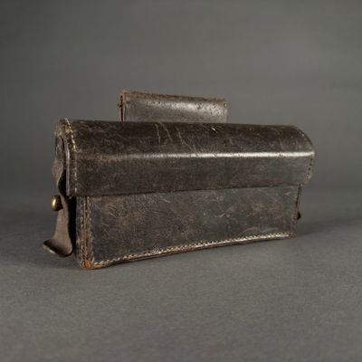 leather case for a camera on a gray background