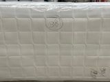 several boxes of mattresses are stacked on the floor in a store