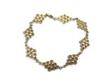 a close up of a bracelet on a white background