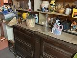a large wooden cabinet with a lot of dishes on it