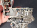 a person holding a silver object in their hand