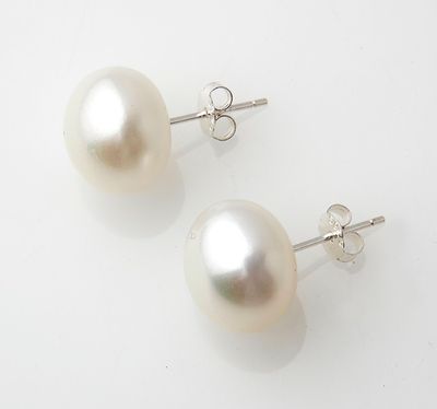 a pair of pearl earrings on a white background