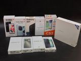 several boxes of various cell phones sitting on a table next to each other