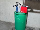 a green trash can with a lot of cleaning products in it