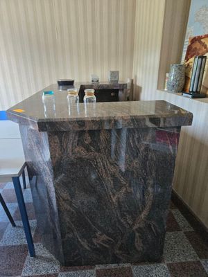 a marble counter top in the middle of a room