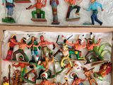 many figurines of different people in a box