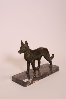 statue of a dog on a marble base on a white background