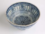 a blue and white bowl sitting on a white surface