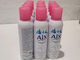 four bottles of axex lotion sitting on top of a counter