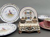 many plates and cups on the table with a bird on them