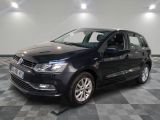 the black volkswagen polo is parked on a checkered tile floor