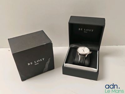 an image of a watch in a black box on a white surface