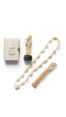 a small box with some items in it on a white surface
